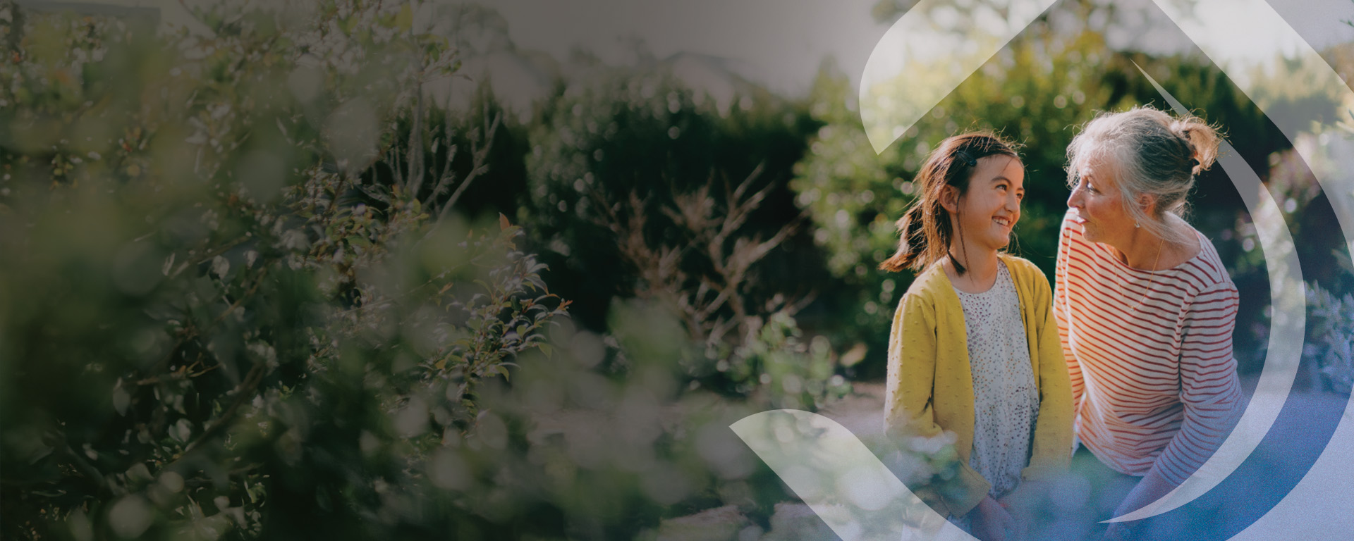 Grandmother and granddaughter smiling in nature