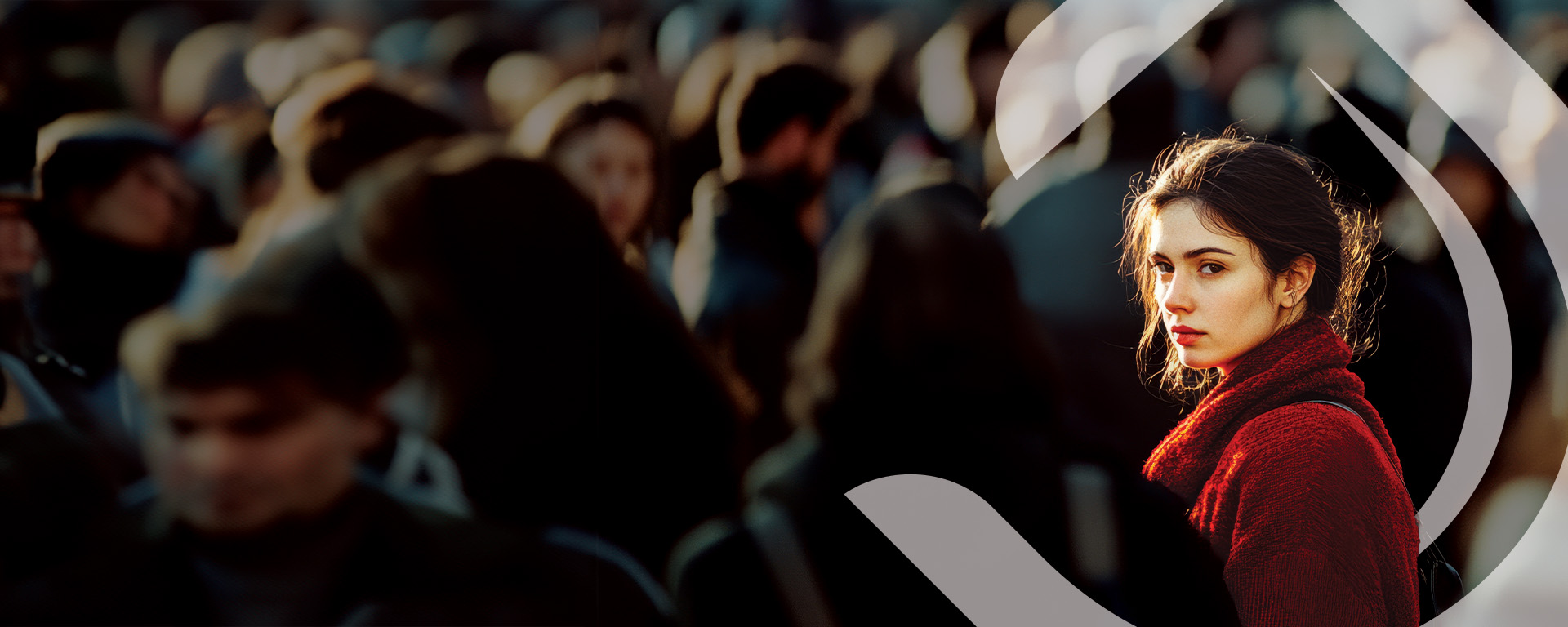 Young woman in a crowd looking directly at the camera