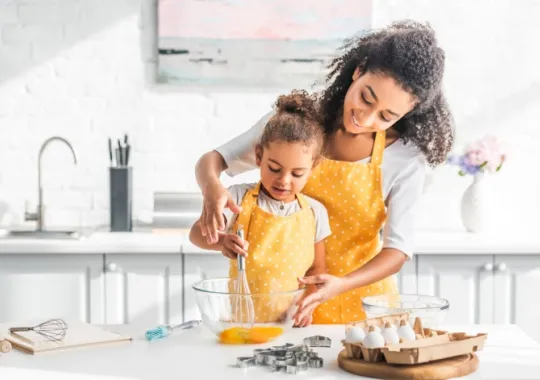 mother cooking with daughter